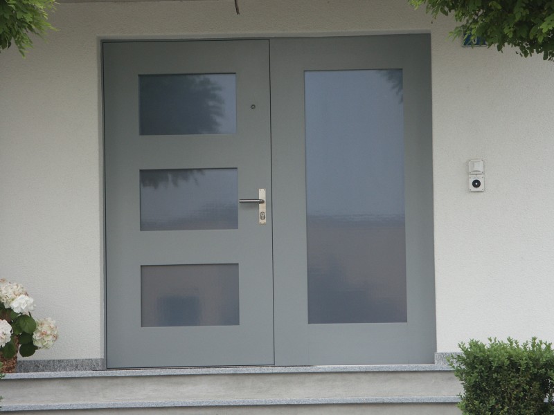 Eingangstüre von der Firma Weidmann AG in Möhlin. Graue Türe mit Milchglasfenster und Erweiterungsmöglichkeit.